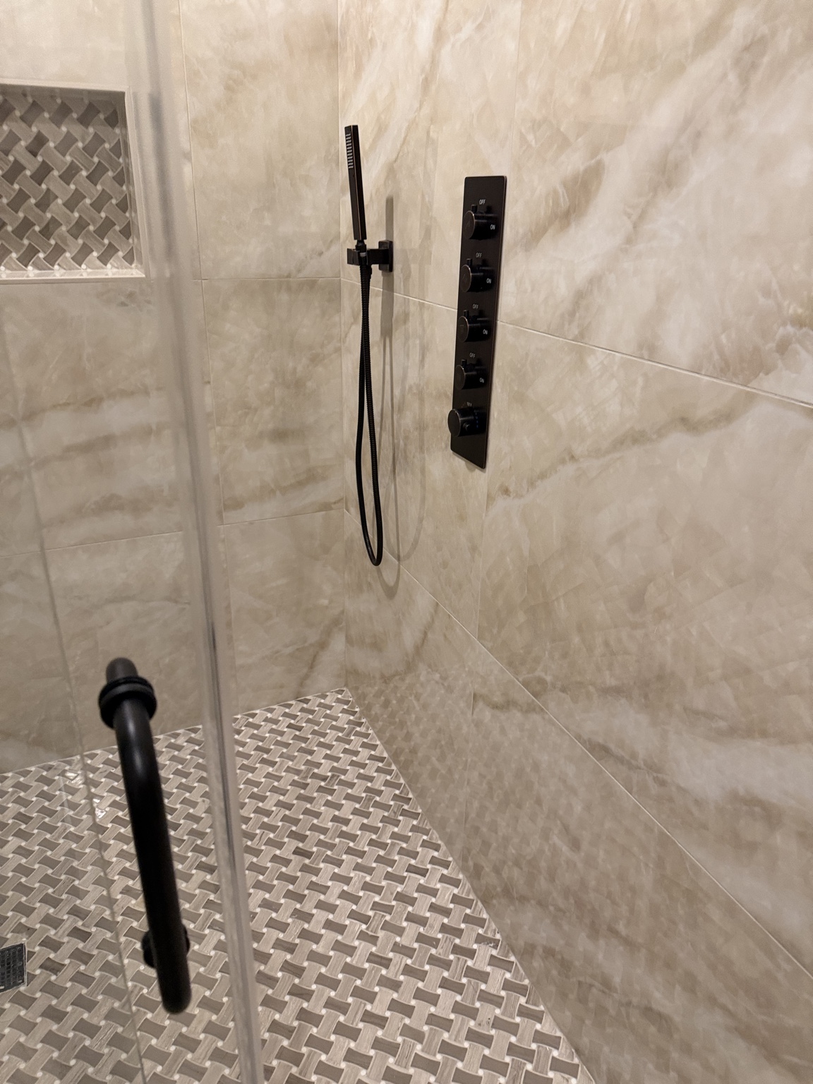 Modern black shower controls and handheld shower