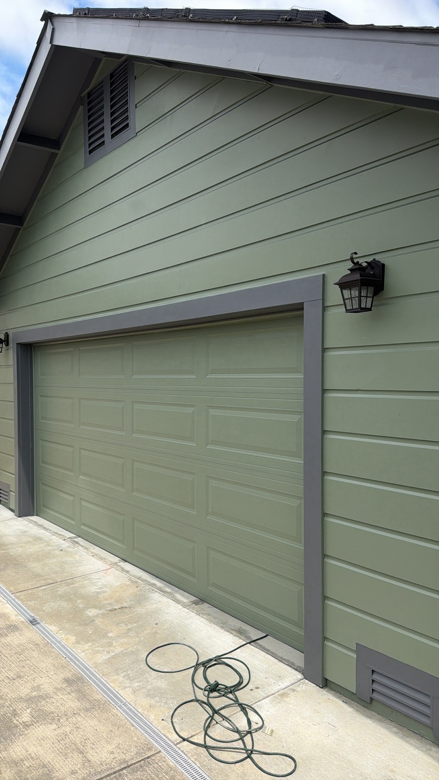 Fresh green and gray exterior house paint around a garage